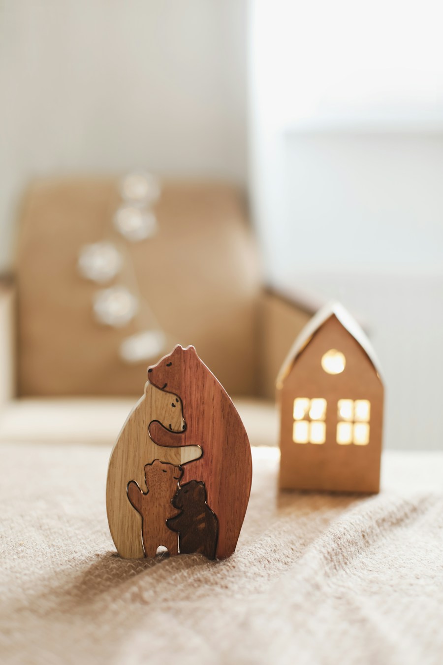 Nested wooden bear family puzzle beside a wooden house