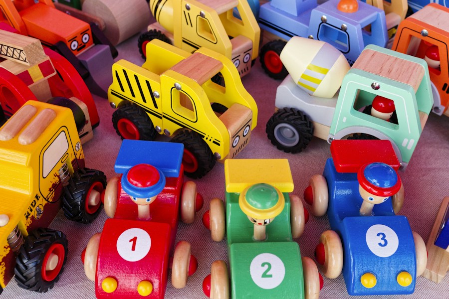 A collection of colourful toy cars, trucks and racing vehicles