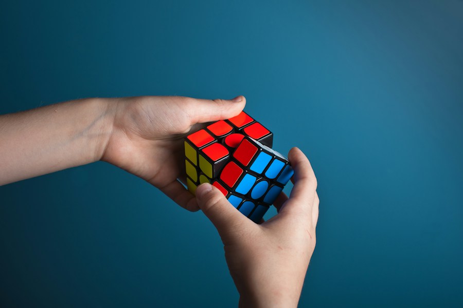 Hands turning a colourful three-by-three puzzle cube