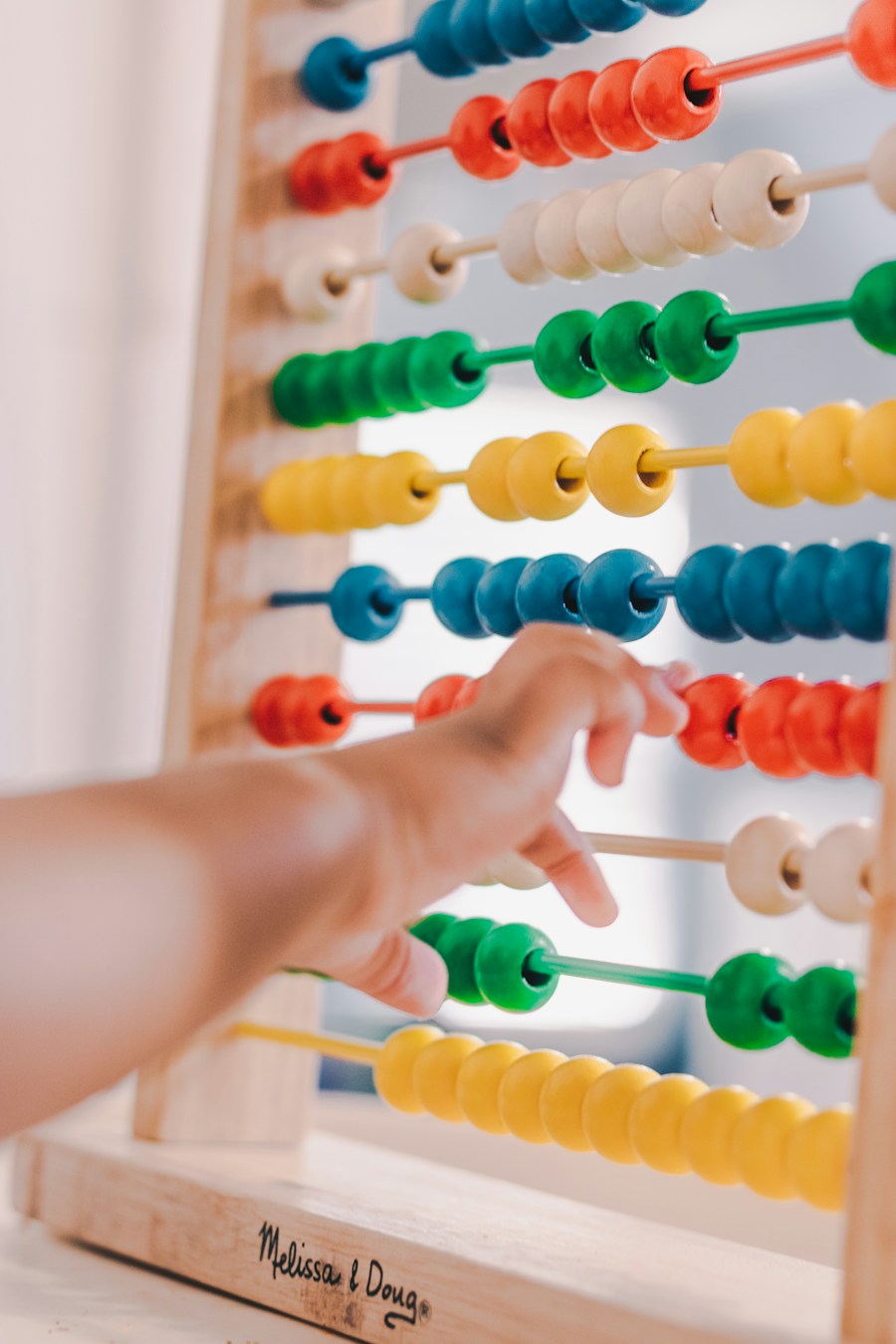 Wooden abacus with rows of colourful counting beads