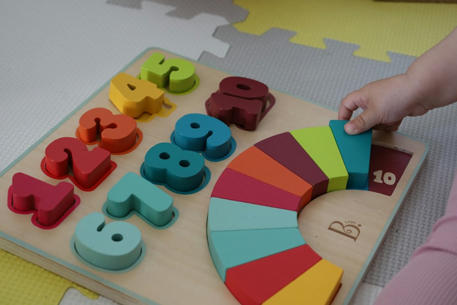 Colourful wooden numbers and rainbow pieces on a puzzle board