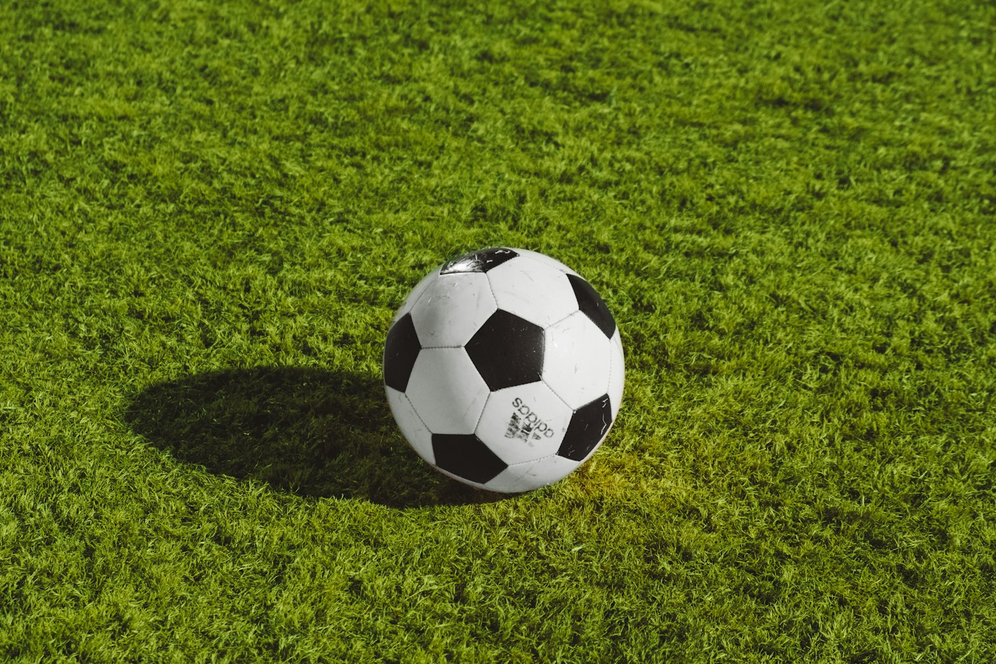 Football on a grass field for active outdoor play