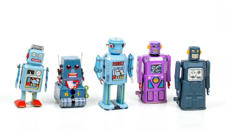 Five retro-style toy robots in blue, purple and grey